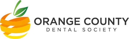 The image shows a logo with text that reads ORANGE COUNTY DENTAL SOCIETY and includes an illustration of a stylized orange with a leaf on top, suggesting a connection to the name and possibly indicating a theme related to the locality or industry.